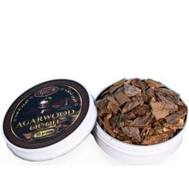 Agarwood chips in an open tin container.