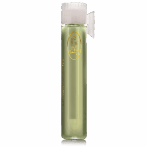 A tall, green glass vial with a white cap and gold emblem.