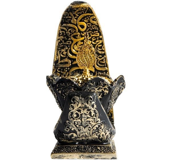 Intricately carved black and gold tribal mask sculpture.